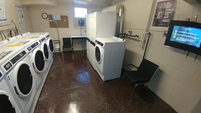 laundry area with stacked washing maching and dryer and washing machine and clothes dryer