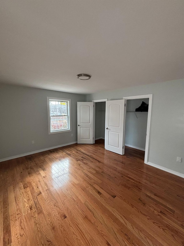 unfurnished bedroom with hardwood / wood-style floors