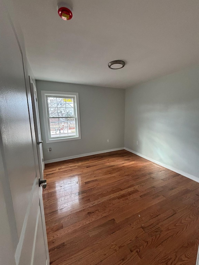 empty room with dark hardwood / wood-style floors