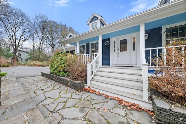 doorway to property with a porch