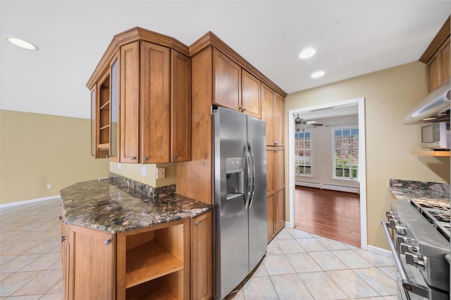 kitchen featuring appliances with stainless steel finishes, a baseboard radiator, light tile patterned floors, and ceiling fan