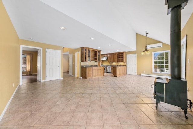 kitchen featuring dishwasher, a wood stove, an AC wall unit, decorative light fixtures, and a chandelier