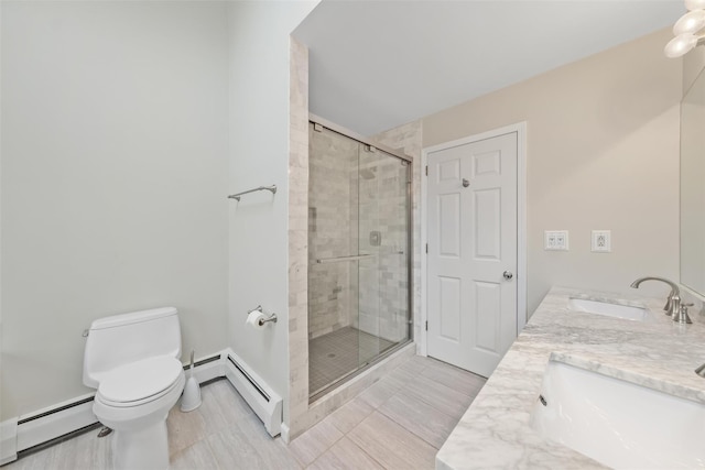 bathroom featuring vanity, toilet, a shower with door, and a baseboard radiator