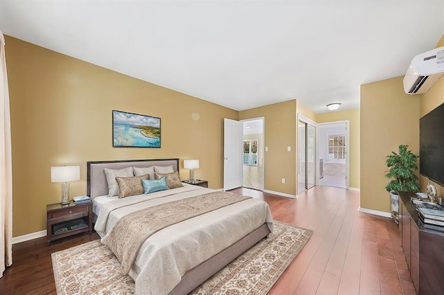 bedroom featuring a wall mounted AC and wood-type flooring