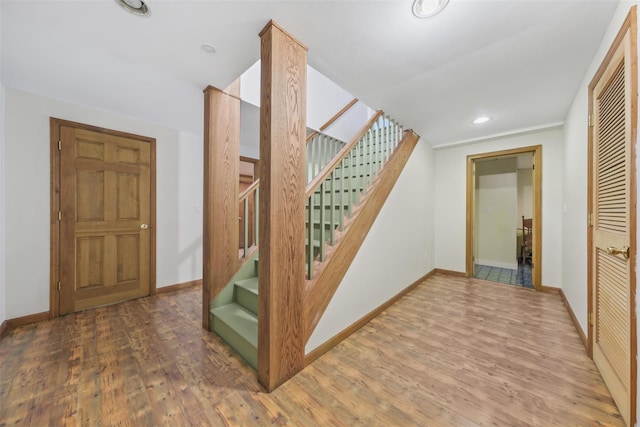 stairs with hardwood / wood-style floors