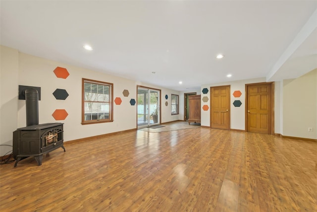 living room featuring light hardwood / wood-style floors and a wood stove