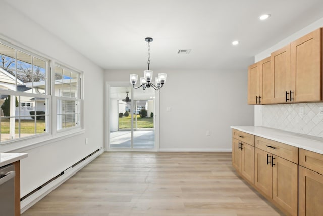 interior space featuring stainless steel dishwasher, a notable chandelier, a baseboard heating unit, pendant lighting, and decorative backsplash