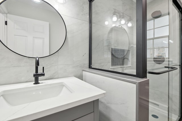 bathroom featuring vanity and tile walls