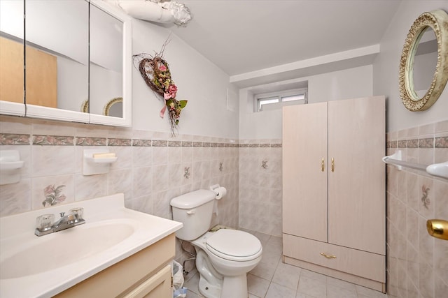 bathroom featuring tile patterned flooring, vanity, tile walls, and toilet