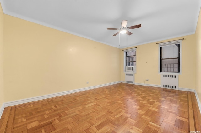 unfurnished room with light parquet floors, cooling unit, crown molding, ceiling fan, and radiator heating unit