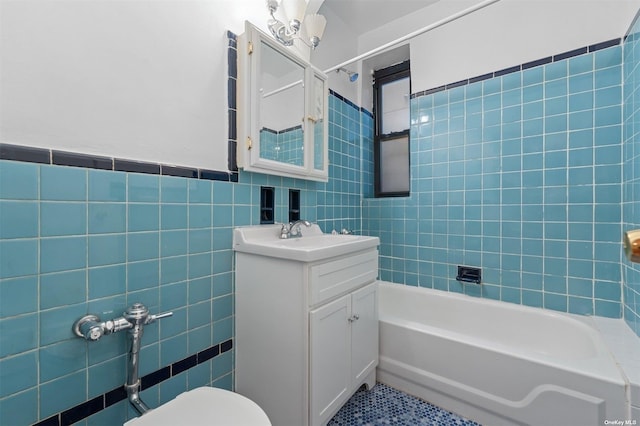 full bathroom featuring vanity, tile walls, tile patterned flooring, toilet, and tiled shower / bath