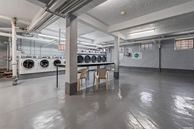 basement with a textured ceiling and washing machine and dryer