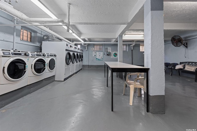 laundry area with washer and dryer and a textured ceiling