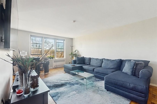 living room featuring parquet floors and radiator