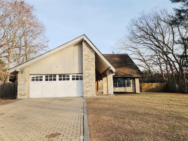 view of front of home with a garage and a front lawn