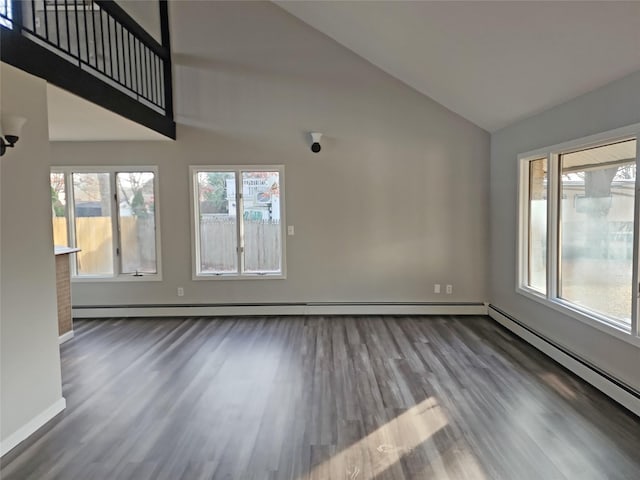 unfurnished living room with hardwood / wood-style flooring, vaulted ceiling, and a baseboard heating unit