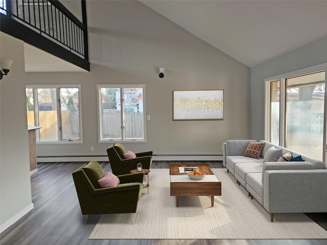 living room featuring baseboard heating, wood-type flooring, and lofted ceiling