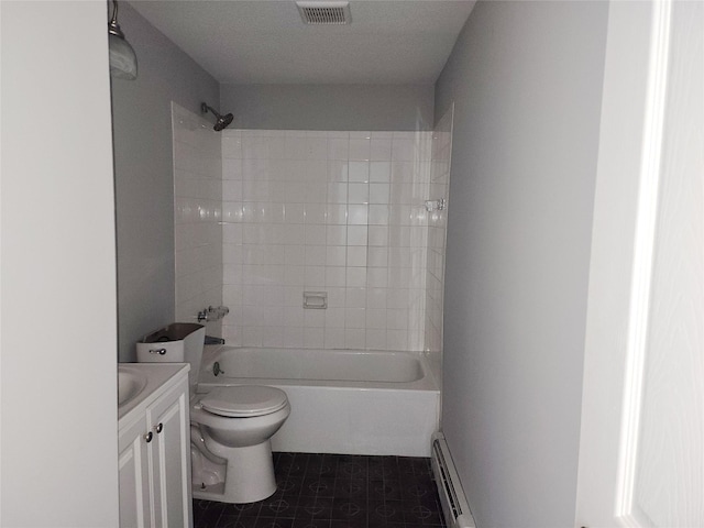 full bathroom featuring vanity, tile patterned floors, tiled shower / bath combo, toilet, and baseboard heating