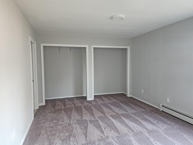 unfurnished bedroom with carpet floors and baseboard heating