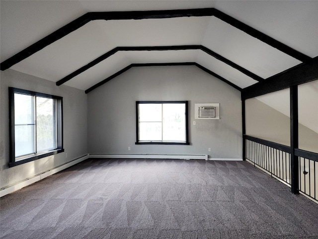 spare room with vaulted ceiling, carpet floors, a wall mounted air conditioner, and a baseboard heating unit