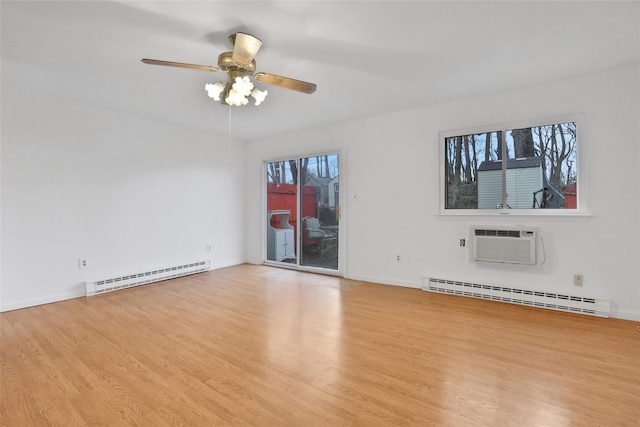 spare room featuring a wall mounted AC, a baseboard radiator, light hardwood / wood-style flooring, and ceiling fan