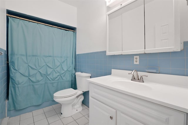 full bathroom featuring tile patterned floors, tile walls, toilet, vanity, and shower / tub combo