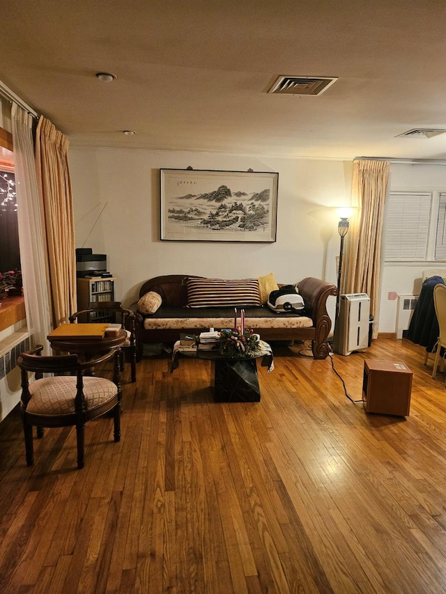 living room with radiator and wood-type flooring