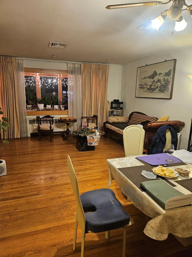 dining room with ceiling fan and wood-type flooring