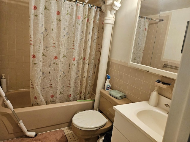 full bathroom with vanity, tile patterned floors, shower / bath combination with curtain, toilet, and tile walls