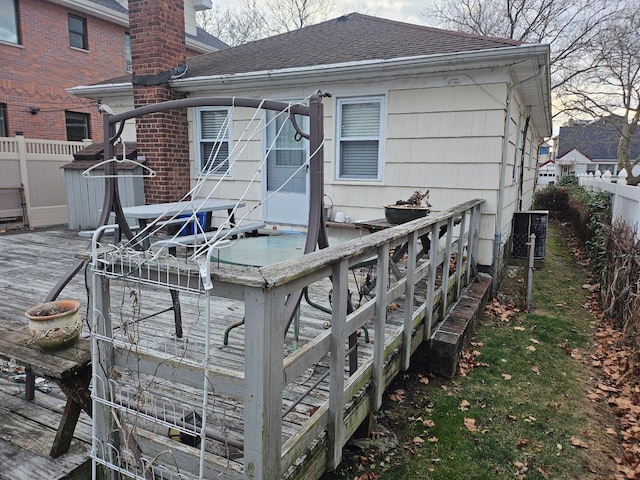 back of property with a wooden deck and central air condition unit