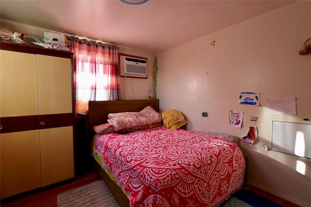 bedroom featuring a wall mounted air conditioner and hardwood / wood-style floors