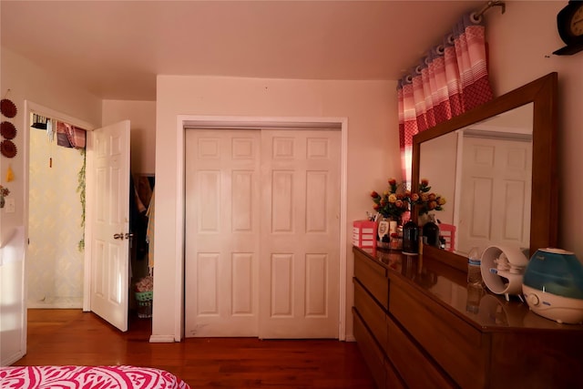 unfurnished bedroom with hardwood / wood-style floors and a closet