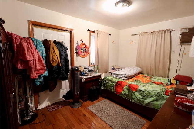 bedroom with hardwood / wood-style floors