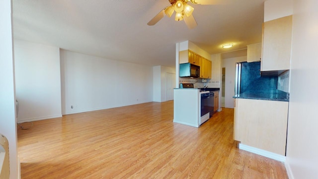 kitchen with white stove, stainless steel fridge, ceiling fan, decorative backsplash, and light wood-type flooring