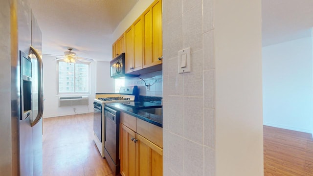 kitchen with ceiling fan, light wood-type flooring, stainless steel appliances, and tasteful backsplash