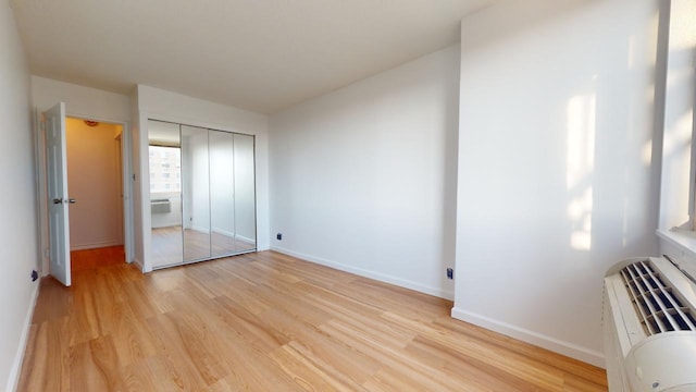 unfurnished bedroom featuring a closet and light hardwood / wood-style floors