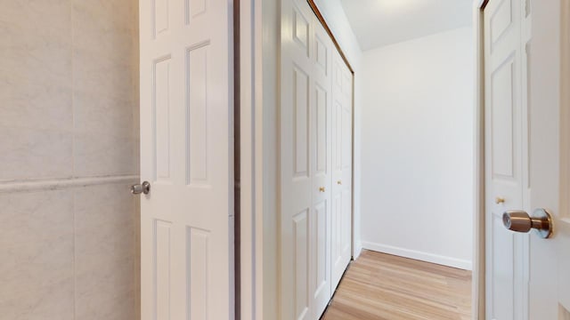 corridor with light hardwood / wood-style floors