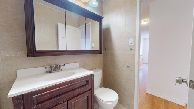 bathroom with backsplash, tile walls, toilet, and vanity