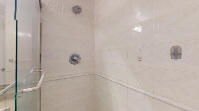 bathroom with tiled shower