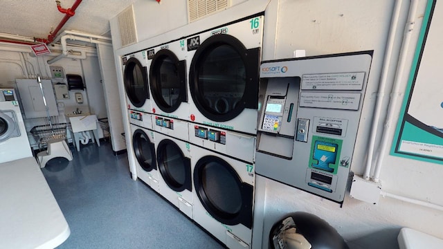 clothes washing area featuring stacked washer / dryer, independent washer and dryer, and sink