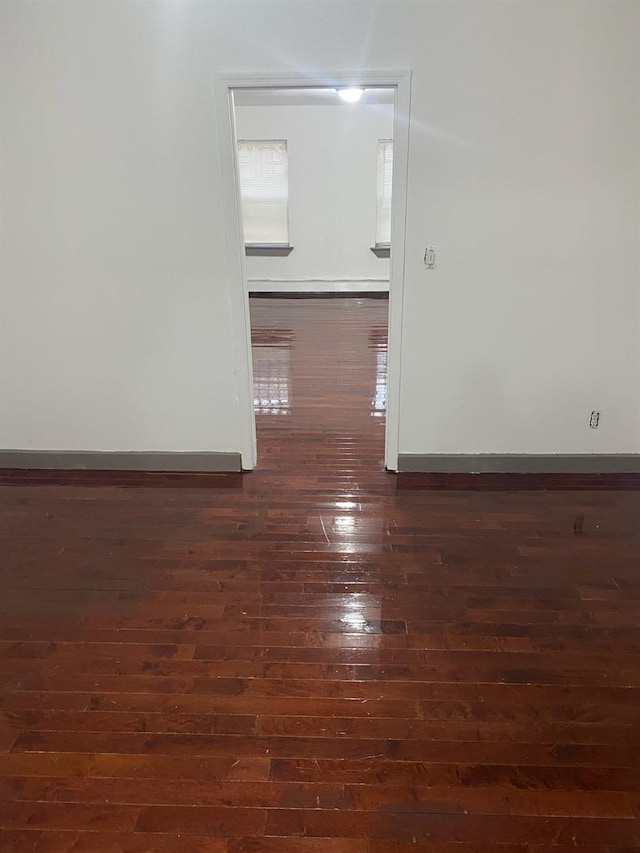 spare room with dark hardwood / wood-style floors