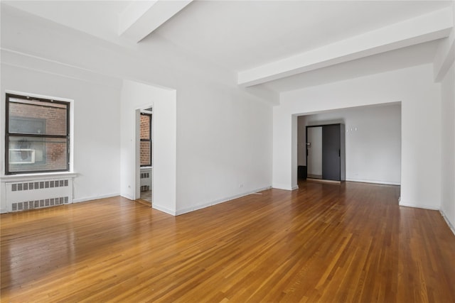 unfurnished living room with beam ceiling, radiator, and hardwood / wood-style floors