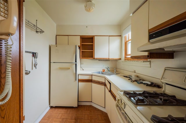 kitchen featuring white cabinetry, sink, light parquet flooring, and white appliances