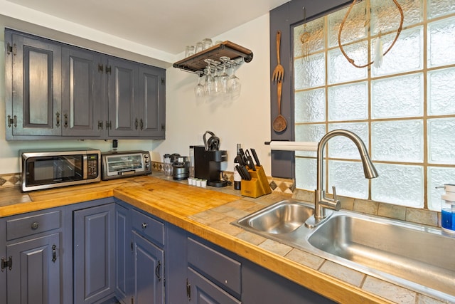 kitchen with wood counters and sink