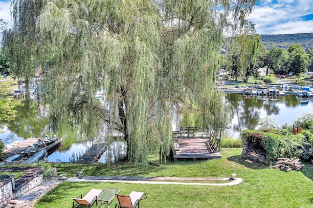 exterior space with a lawn and a water view