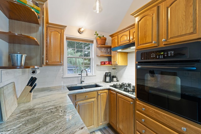 kitchen with gas cooktop, tasteful backsplash, lofted ceiling, and sink