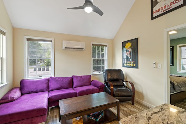 living room featuring a wall mounted AC, a wealth of natural light, light hardwood / wood-style flooring, and lofted ceiling