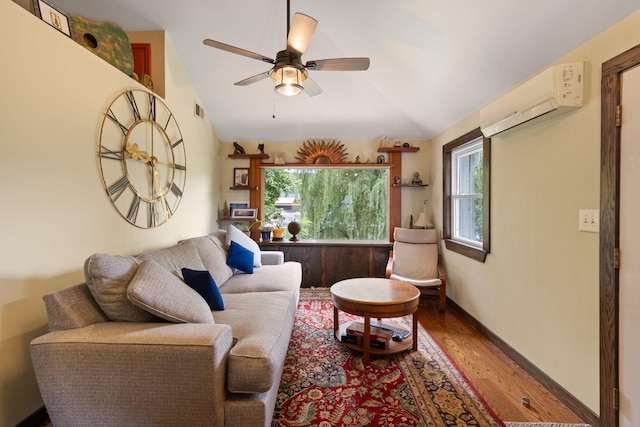 living room featuring wood-type flooring, an AC wall unit, ceiling fan, and lofted ceiling