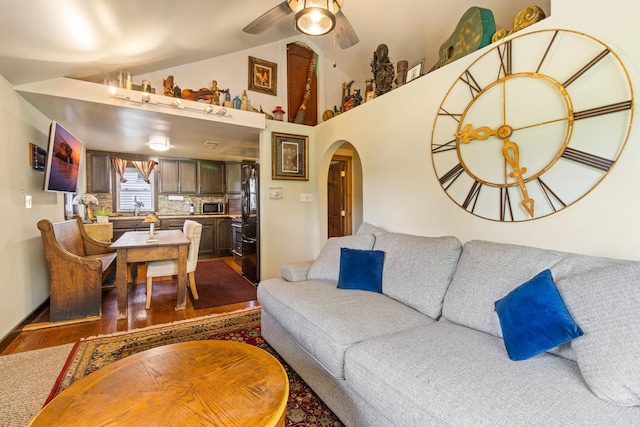 living room featuring wood-type flooring and ceiling fan