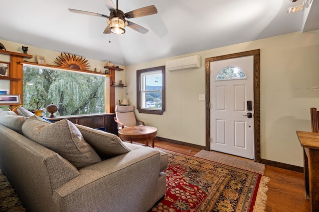 living room featuring hardwood / wood-style floors, vaulted ceiling, a wall mounted AC, and ceiling fan